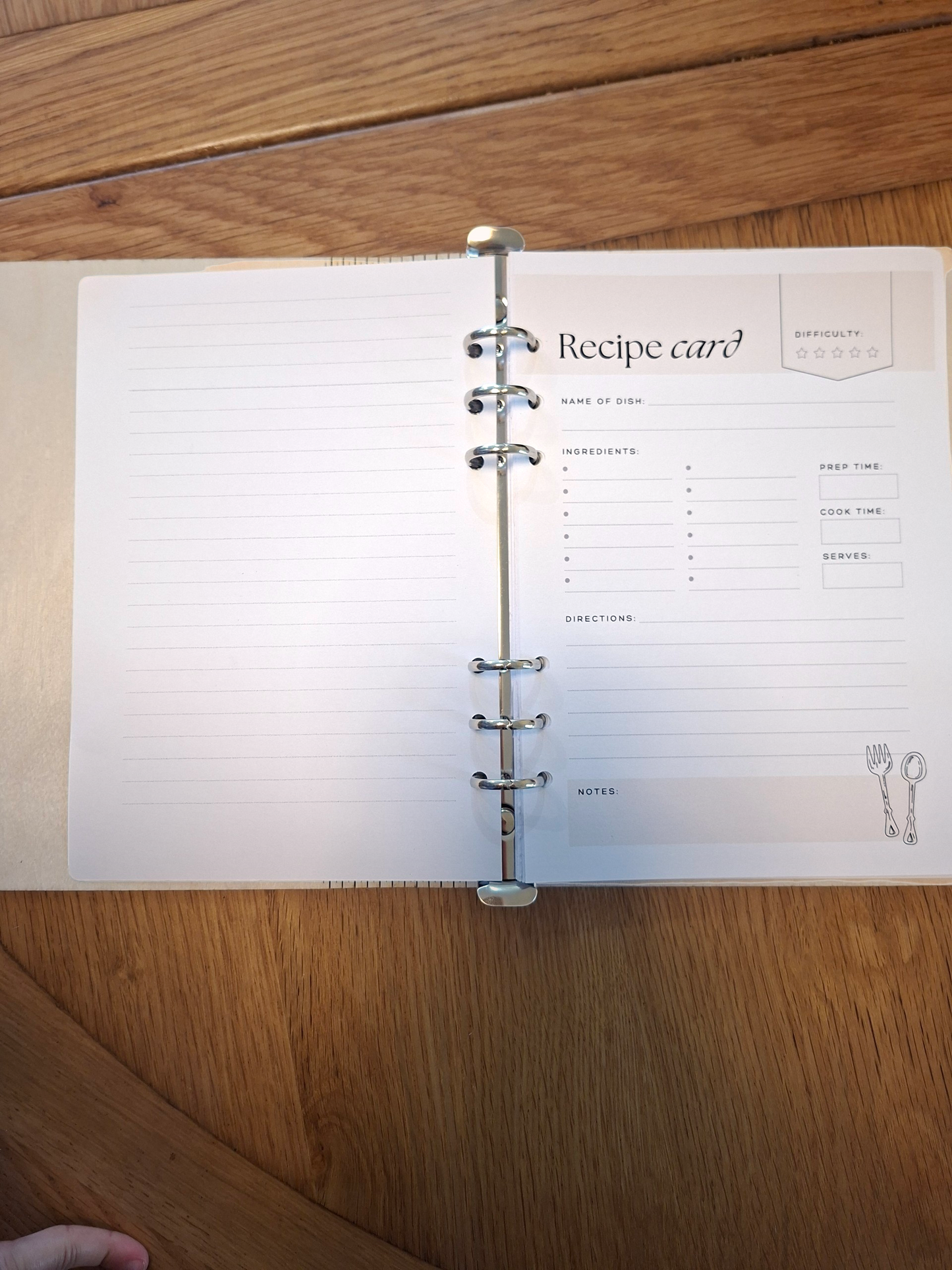 Open notebook with a recipe card on a wooden surface