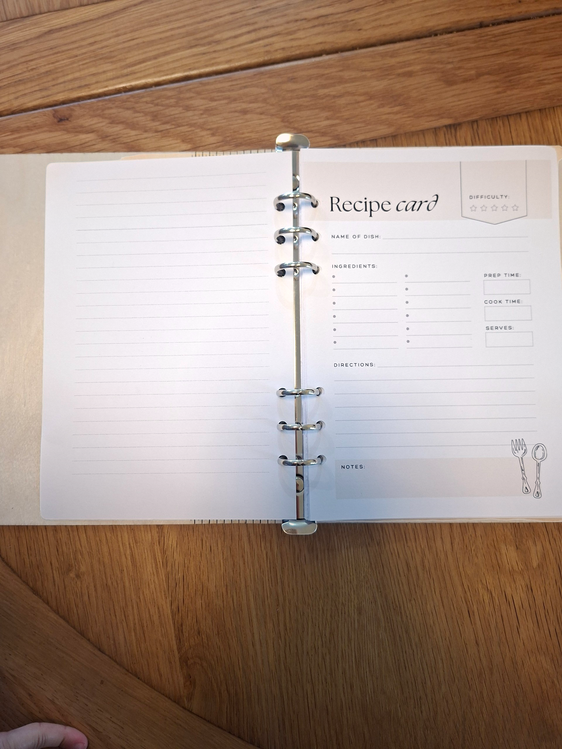 Open notebook with a recipe card on a wooden surface
