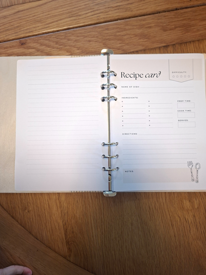 Open notebook with a recipe card on a wooden surface